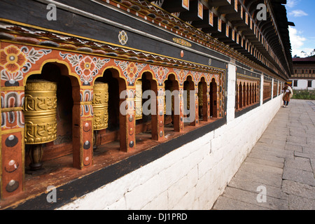 Bhutan, Thimpu Dzong, devotee spinning prayer wheels around prayer hall Stock Photo