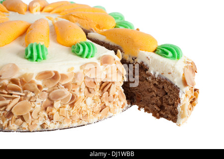 Carrot cake decorated with icing, nuts around the side and piped carrots on the top isolated on white background. Stock Photo