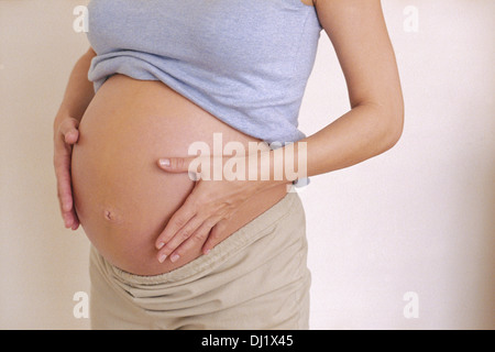Pregnant Woman Holding Stomach Stock Photo