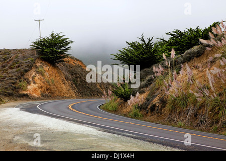 Road in the fog, leading to Half Moon Bay, California Stock Photo