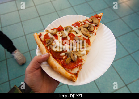Slice of Mushroom pizza, Staten island ferry terminal, New York, United States of America. Stock Photo