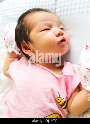Newborn Asian baby girl lies on a blanket Stock Photo
