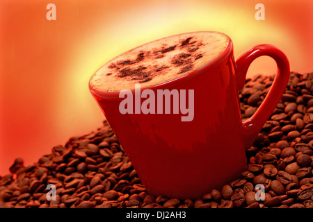 A cup of cappuccino on eye-catching orange backgrounds with fresh coffee beans Stock Photo