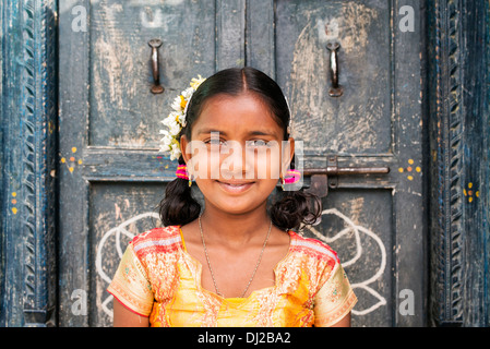 Rural Indian village girl standing in front of house doors. Andhra Pradesh, India Stock Photo