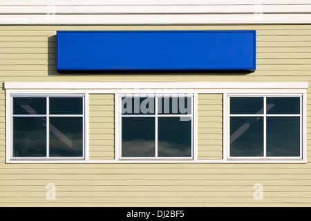 Blank Sign Above Windows Outside For Commercial Hospital Clinic or Business Office Building Stock Photo