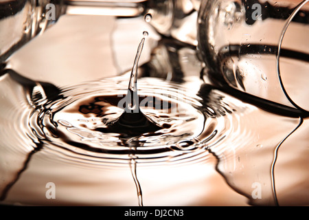 Closeup Pictures water drops a beautiful shape in Basin on bright colors background. Stock Photo