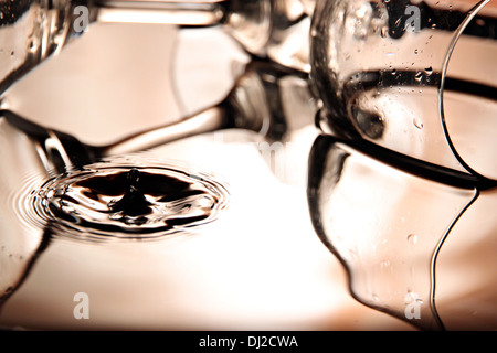 Closeup Pictures water drops a beautiful shape in Basin on bright colors background. Stock Photo