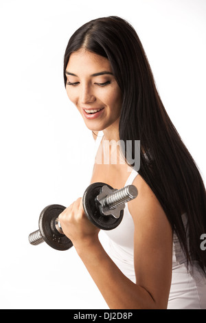 Cute fitness girl working out with dumbbells over white Stock Photo