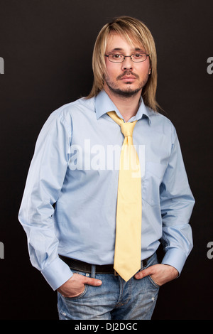 Portrait of handsome young man against black background Stock Photo