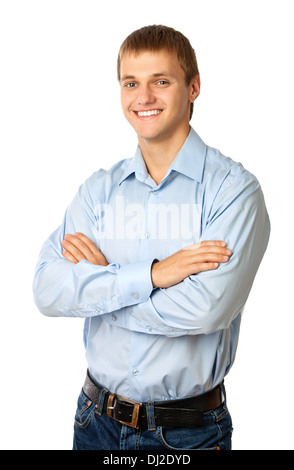 Smiling young man standing with his arms folded against white Stock Photo