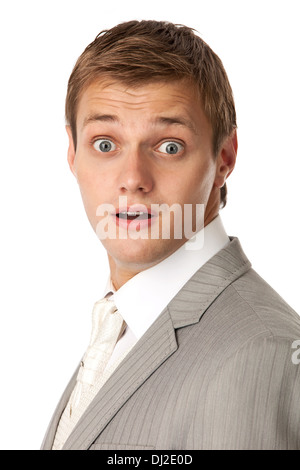 Portrait of a young man in a suit looking very shocked Stock Photo