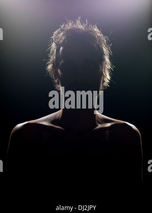 portrait of young caucasian male with dramatic lighting looking at camera Stock Photo