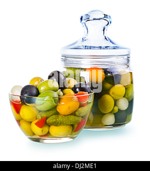 Green and black olives in jar , with pickled cucumbers, garlic, pepper Stock Photo