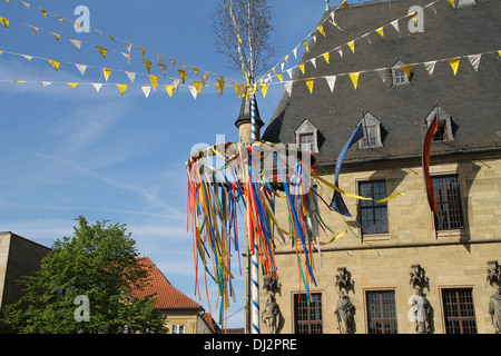 A maypole before the town hall Stock Photo
