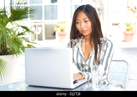 Pretty asian girl working on her laptop, businesswoman or student Stock Photo