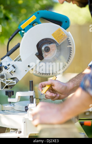 Carpenter's Hands Marking On Wood At Table Saw Stock Photo