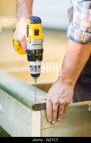 Carpenter's Hands Using Drill On Wood Stock Photo