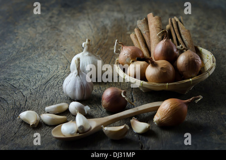 garlic , onion and cinnamon on wooden board ( food ingredients ) Stock Photo