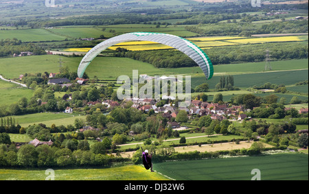 Paraglider taking off from Devil's Dyke,overlooking The Weald (+ Fulking village),South Downs, near Brighton, Sussex, England,UK Stock Photo