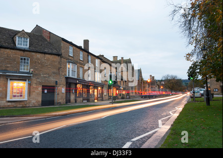 Light trails from traffic at dusk in Broadway the Cotswolds UK Stock Photo