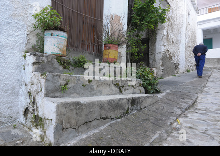 Spanish man walking a steep street in Capileira, Stock Photo