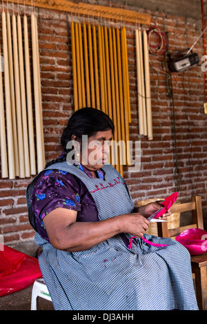 A Zapotec indigenous woman creates bees wax flowers for the Day of the Dead festival known in spanish as Día de Muertos October Stock Photo