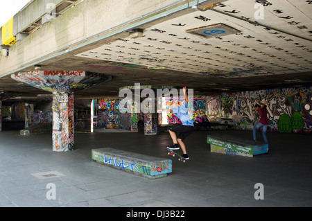 Skateboarders doing tricks under the Royal Festival Hall and the Southbank Centre on the South Bank, London, England, UK. Stock Photo