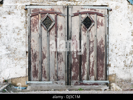 Front doors to an old neglected building Stock Photo