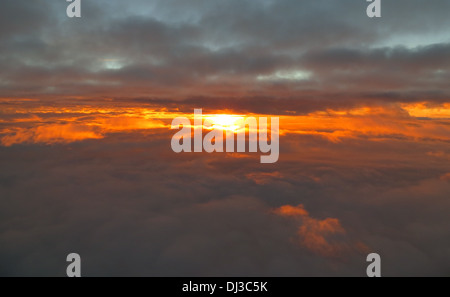 Aerial sunrise. Beautiful unusual aerial view of sun rise, caught between cloud layers. Stock Photo