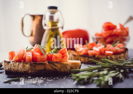 Two bruschettas with fresh tomato and rosemary Stock Photo