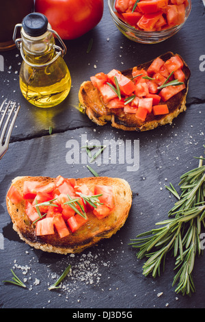 Two bruschettas with fresh tomato and rosemary Stock Photo