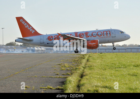 easyJet Airbus A319 G-EZAC touching down (with tyre smoke) at London Southend Airport, Essex, UK Stock Photo