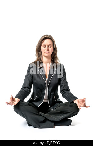 Business woman in black suit performs a yoga exercise on white background Stock Photo