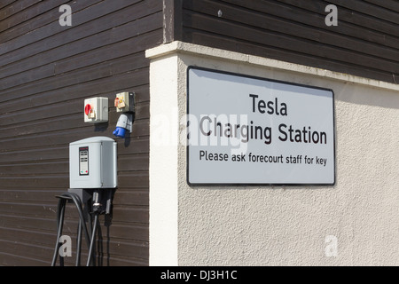 Tesla car charging point at Gretna motorway services in a parking bay