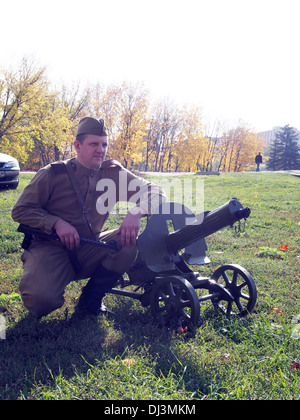 re-enactor in the form of a Red Army soldier with a machine gun Maxim Stock Photo