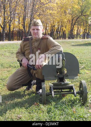 re-enactor in the form of a Red Army soldier with a machine gun Maxim Stock Photo