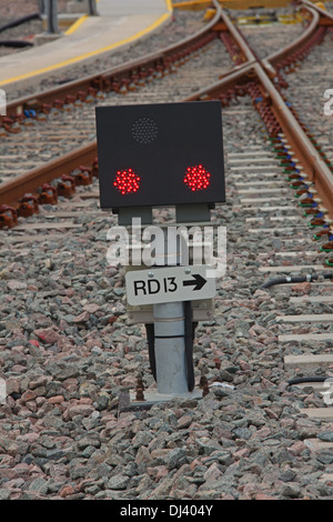 A newly installed Ground position signal showing two red LED lights protecting a depot exit. Stock Photo