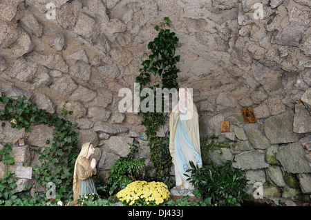 Virgin Mary in a grotto of Lourdes Stock Photo