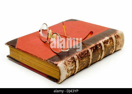 Old red leather bound  reading vintage book with reading eye glasses on it, Cut Out. Stock Photo