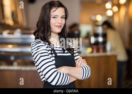 Pretty Waitress Standing Arms Crossed In Cafeteria Stock Photo