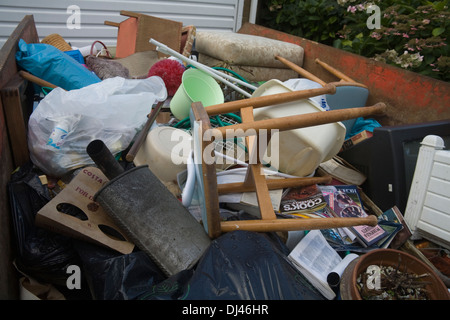 UK Skip full of household rubbish from a house clearance Stock Photo