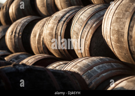 Whisky casks piled up in a warm evening light Stock Photo