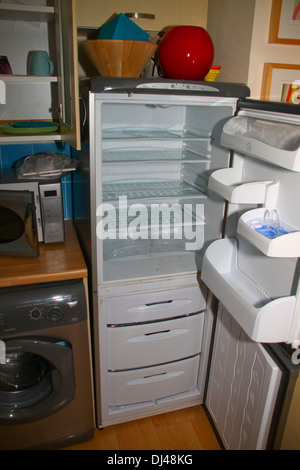 Empty fridge freezer in domestic kitchen Stock Photo