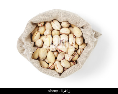 roasted salty pistachios nuts in sack bag from above, isolated on white background Stock Photo