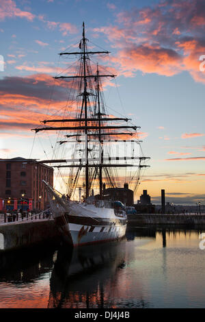 Tall ship in Albert dock in Liverpools dockland; Liverpool, Merseyside, UK 21st November 2013. UK Weather. Sunset over Worthington Docks. Britain's biggest operational Traditional rig tall sailing ship Stavros S Niarchos (Tall Ships Youth Trust) berthed in the Albert Dock complex for her first ever winter lay-up in Liverpool. Stavros S Niarchos is a British brig-rigged tall ship owned and operated by the Tall Ships Youth Trust (TSYT). She is primarily designed to provide young people with the opportunity to undertake voyages as character-building exercises, rather than pure sail-training. Stock Photo