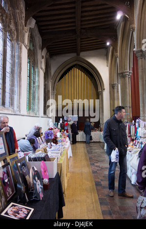 Deconsecrated church: stallholders and visitors at a craft fair inside St Peter's church in Sudbury, Suffolk. Stock Photo