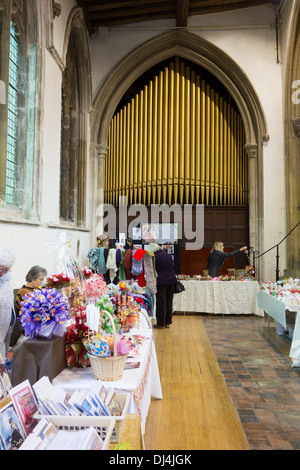 Deconsecrated church: stallholders and visitors at a craft fair inside St Peter's church in Sudbury, Suffolk. Stock Photo