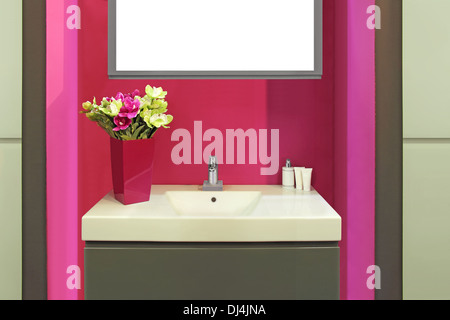 Fragment of a luxury purple bathroom and flowers in a vase on the sink Stock Photo