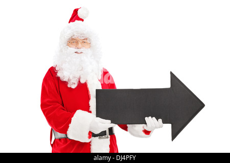 Santa Claus holding black arrow seated on a blank panel isolated on ...