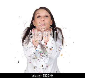 young woman blowing confetti Stock Photo